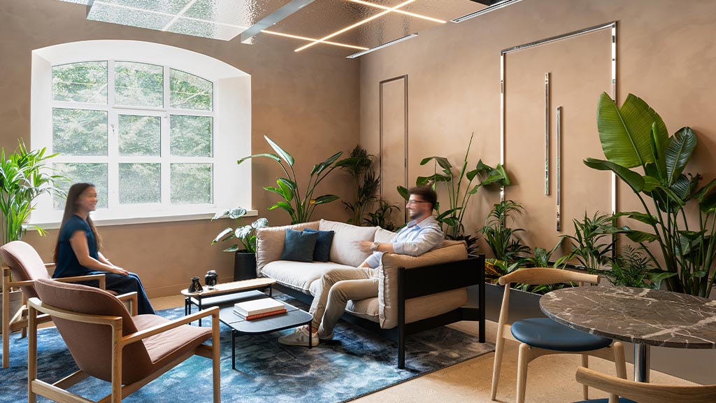 A man and woman are sitting in the Oasis room in Hilson Moran's Living Lab.