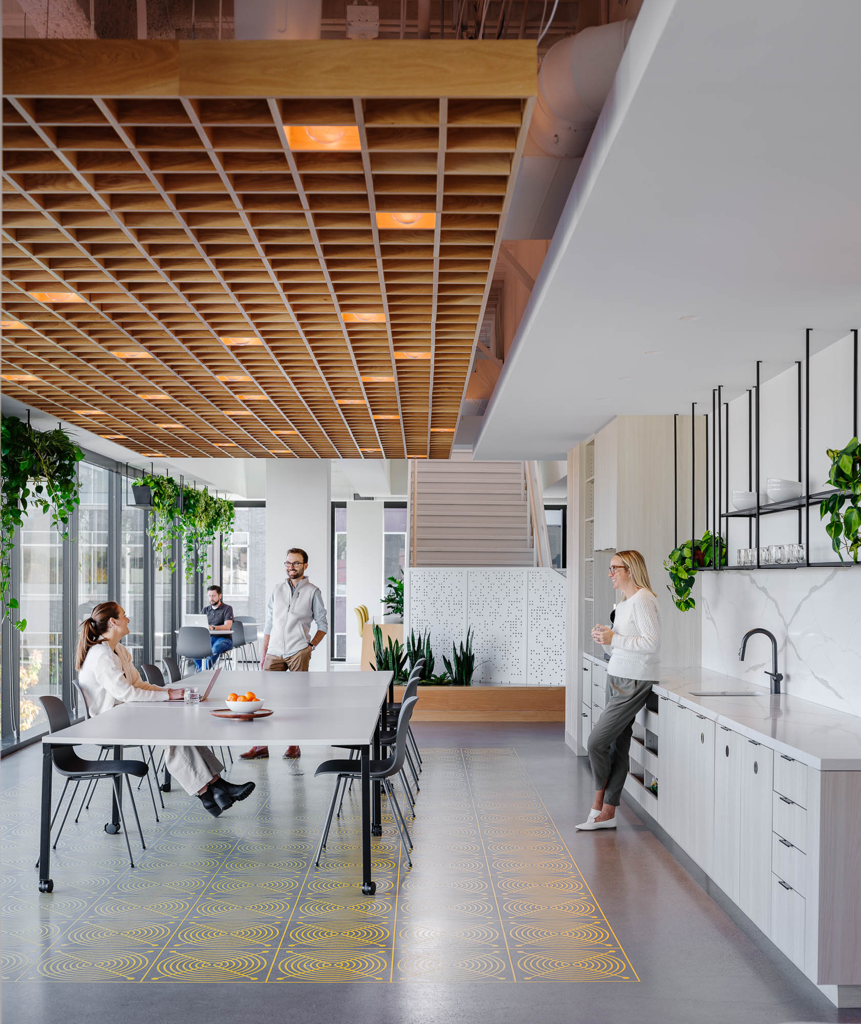 A group of people in a kitchen.
