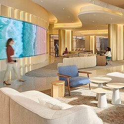 A room with a large screen and chairs.