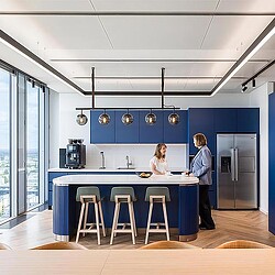 A man and woman in a kitchen.