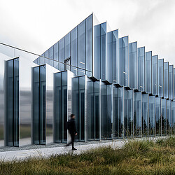 A person walking outside of Burlingame Point amenity building