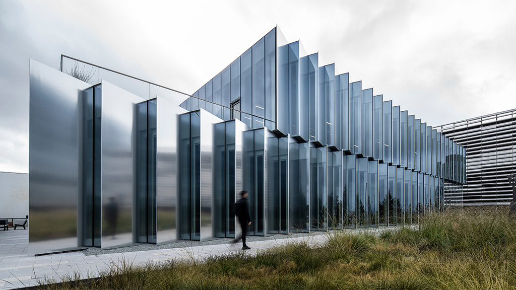 A person walking outside of Burlingame Point amenity building