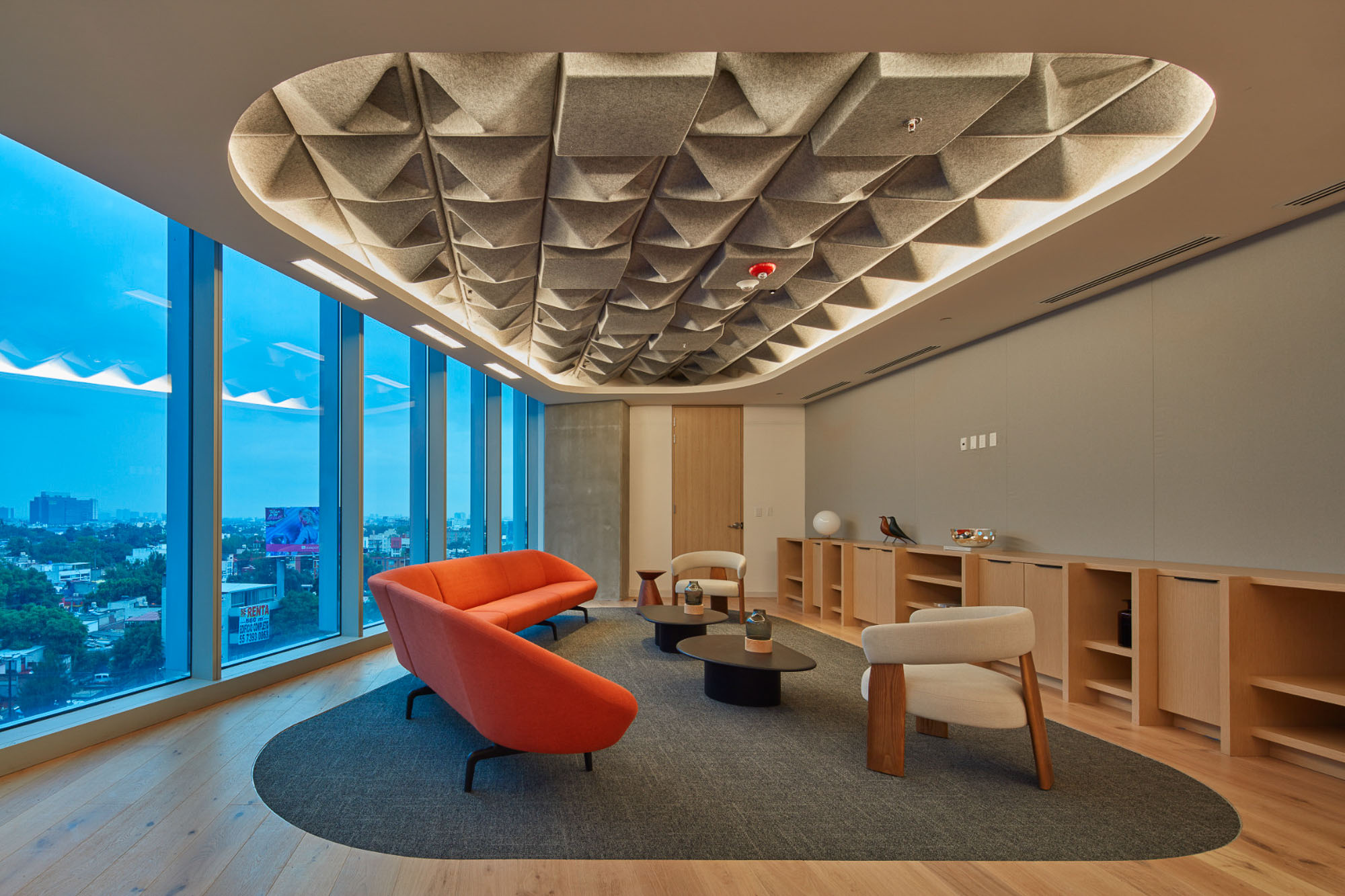 A room with a large ceiling and chairs.