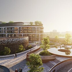 A building with a courtyard and a fountain in front of it.
