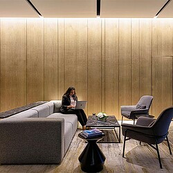 A person sitting on a couch using a laptop.